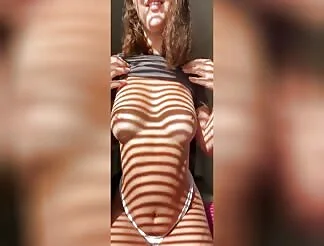 Hot wife teasing her boobs in the shadows