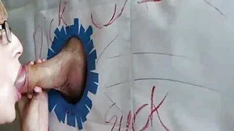 Filthy girl sucks dick through the Gloryhole
